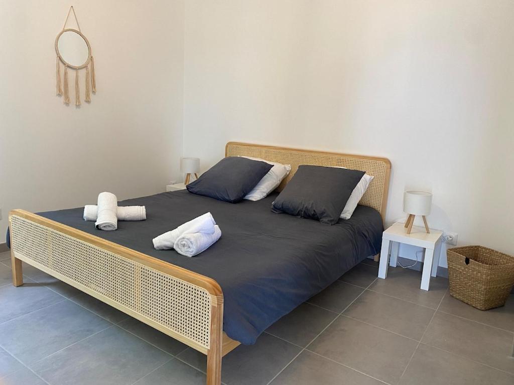 a bed with two pillows on it in a room at la maison dans la prairie fleurie gite bleuet in Saint-Avit-Sénieur