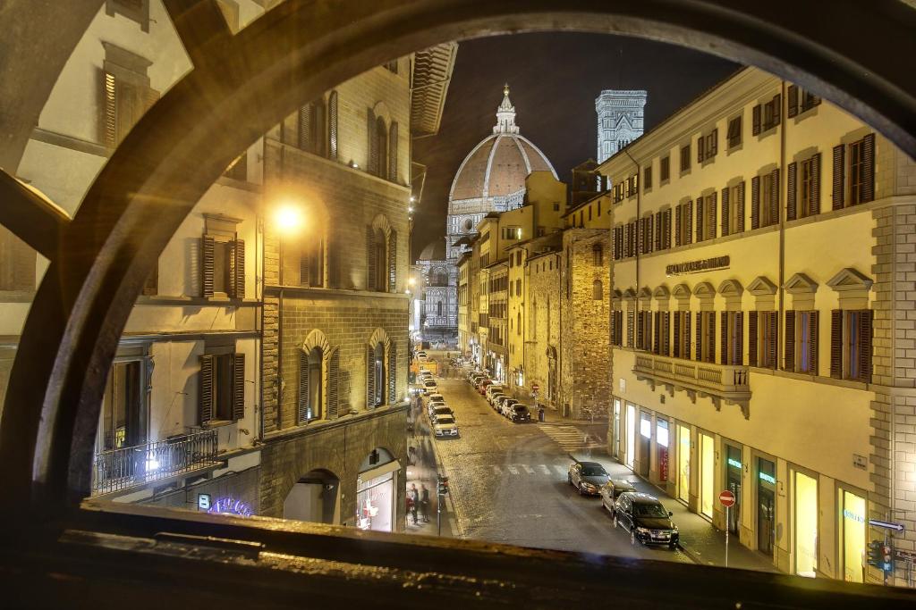 a view from a window of a city street at night at Soggiorno La Cupola Guesthouse in Florence