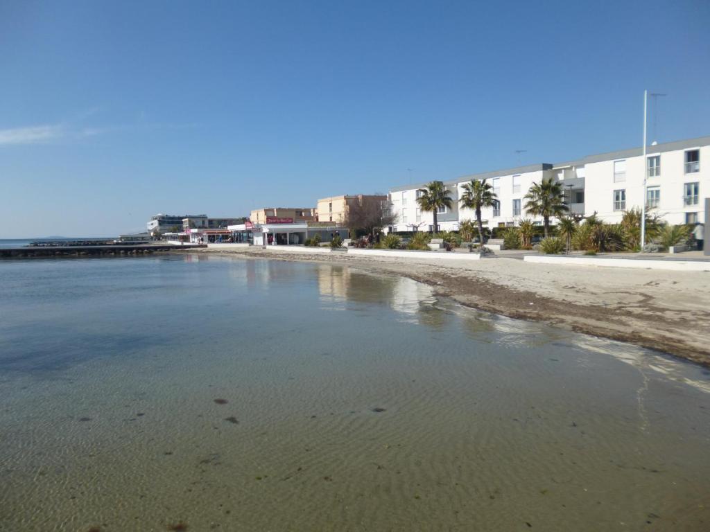 - une vue sur une plage avec des bâtiments en arrière-plan dans l'établissement Les Gémeaux, à Balaruc-les-Bains