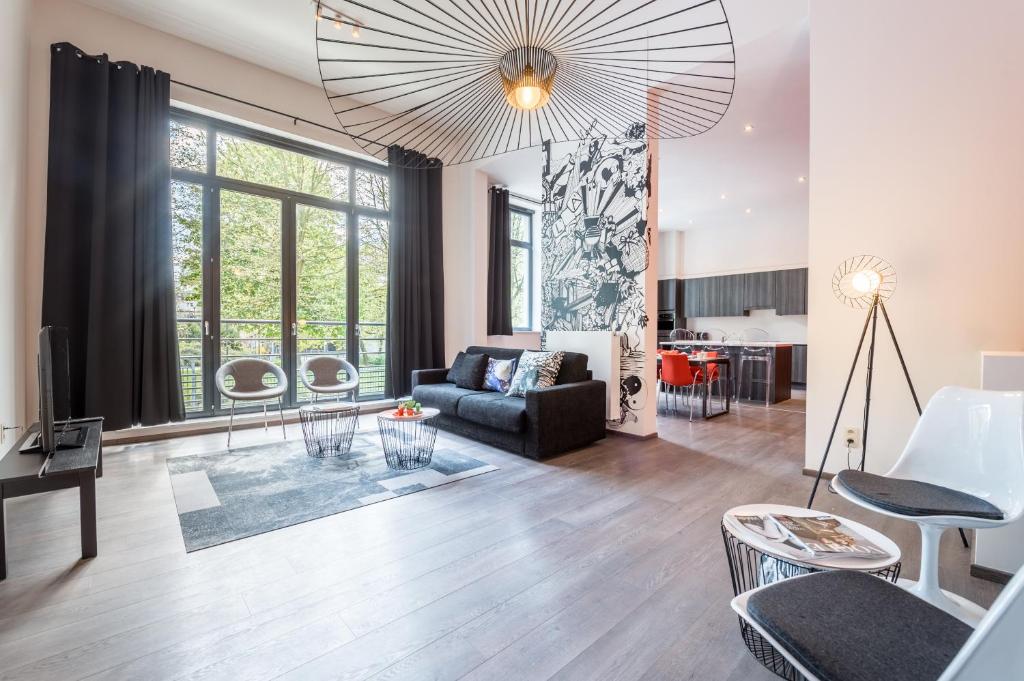 a living room with a couch and a table at Smartflats Design - Berlaymont in Brussels