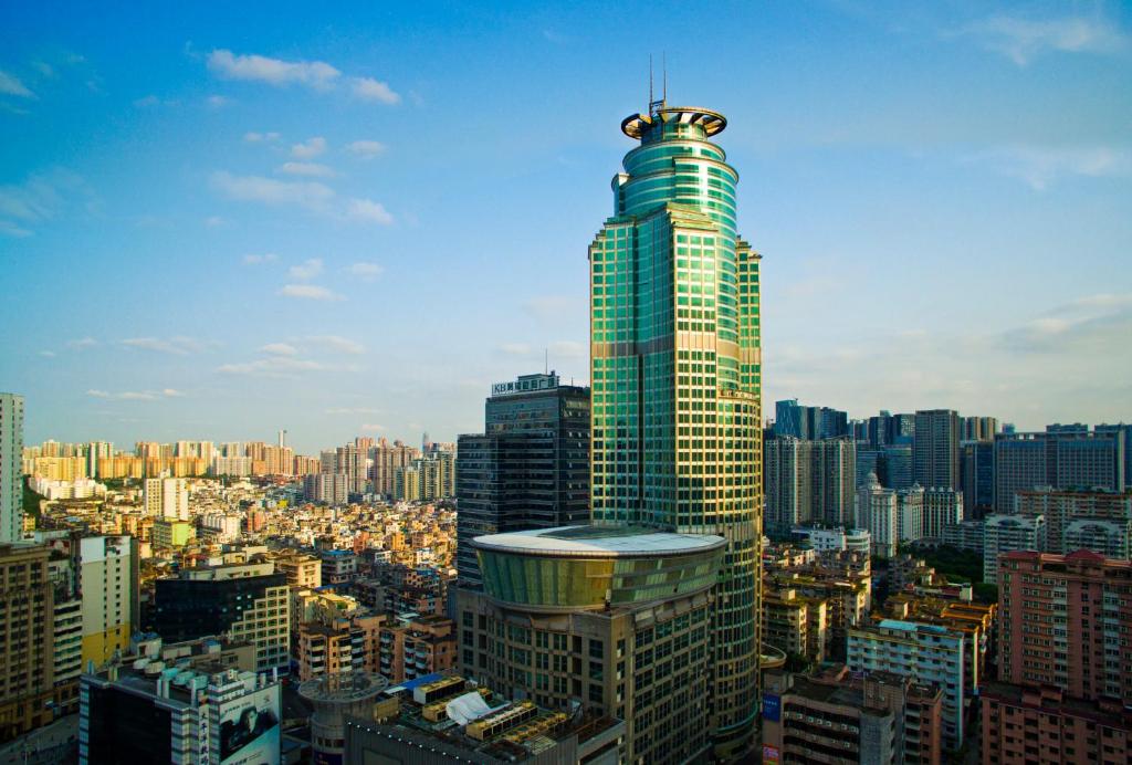 a tall skyscraper in a large city with buildings at Royal Mediterranean Hotel in Guangzhou