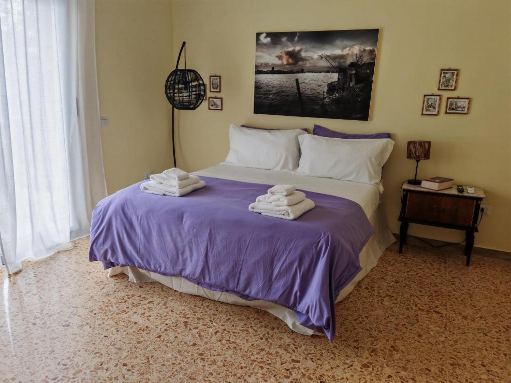 a bedroom with a large bed with towels on it at Le Giramondo Appartamento Le Cavallerizze in Caserta