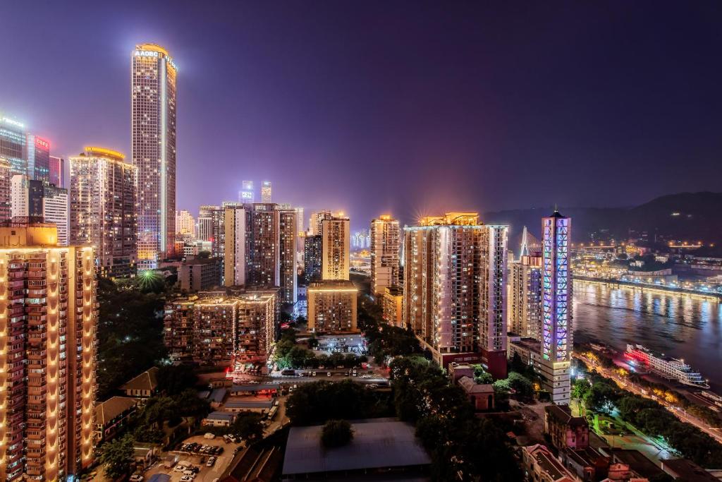 a city lit up at night with tall buildings at 云深处江景公寓 in Chongqing