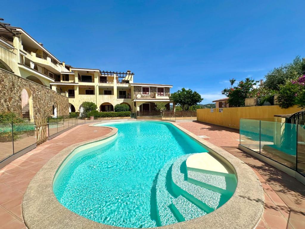 a swimming pool in front of a building at Casa BiBa in Villasimius