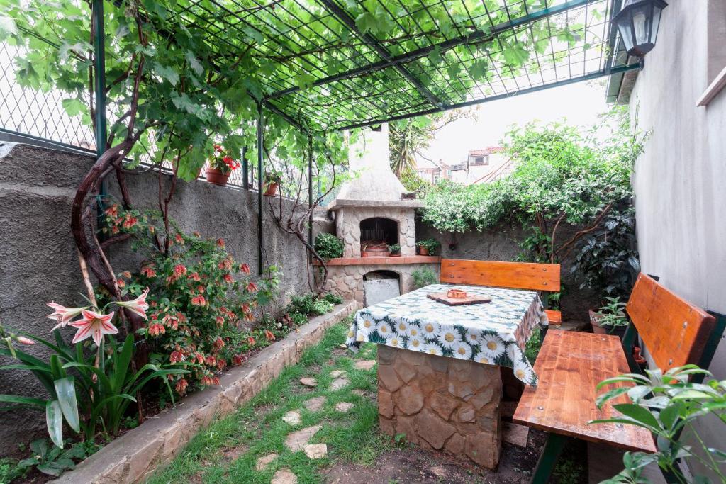 un patio al aire libre con una mesa y una casa de aves en Apartment Franicevic en Split