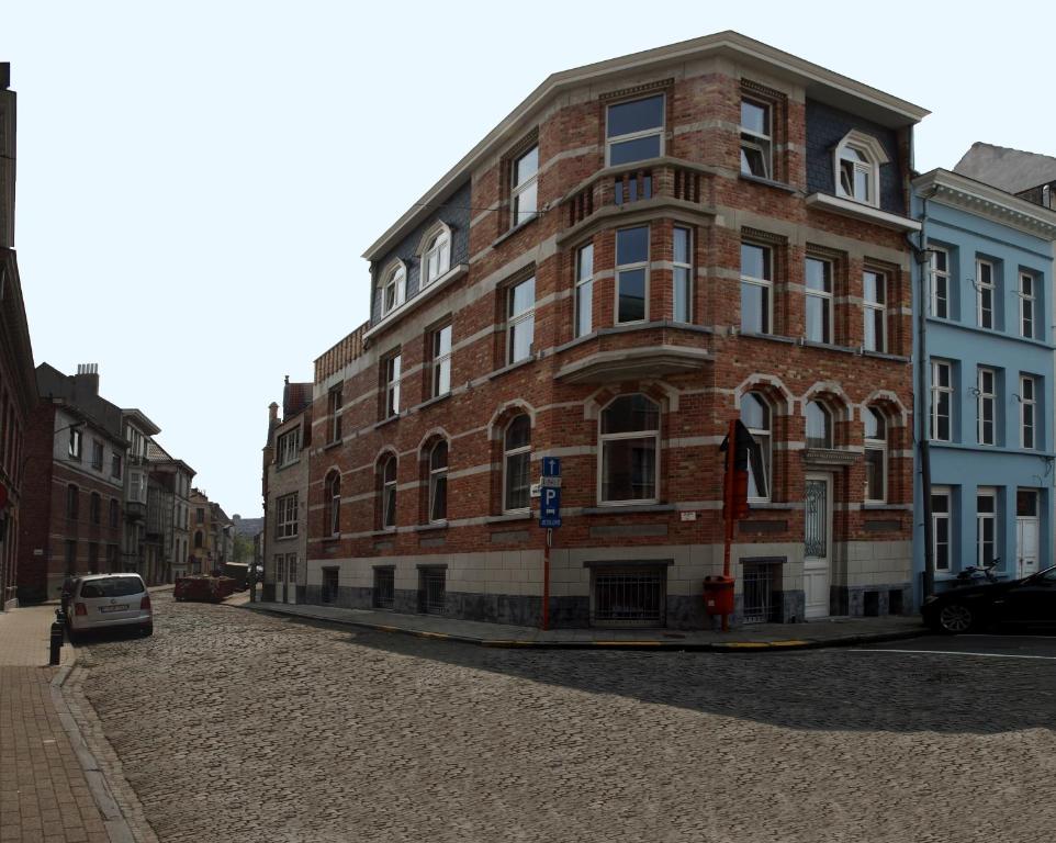 a brick building with a clock on the side of it at Place 2 stay in Ghent