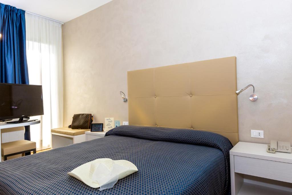 Postel nebo postele na pokoji v ubytování Hotel Touring