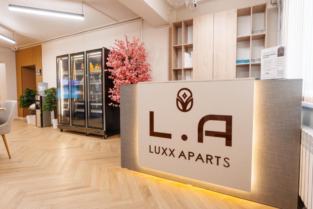 a sign for at Luxx Aparts in Almaty