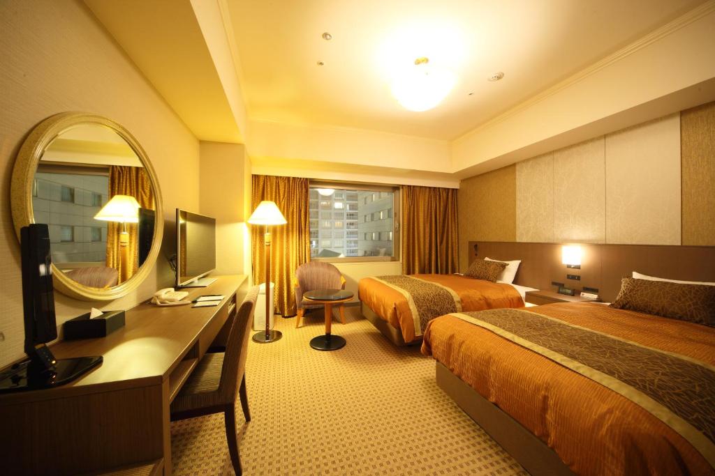 Postel nebo postele na pokoji v ubytování Hotel Metropolitan Nagano