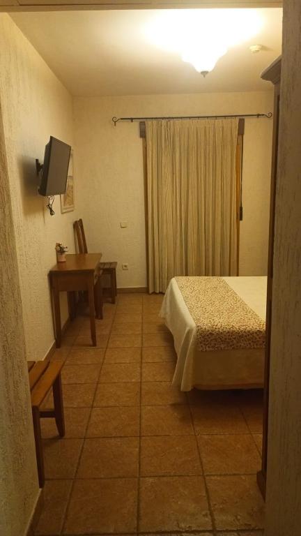 Postel nebo postele na pokoji v ubytování hostal Decerca Prádena