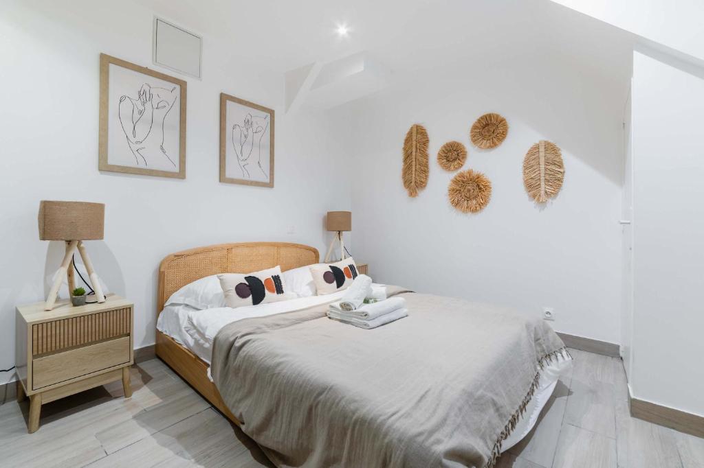 a white bedroom with a bed and a night stand at Appartement neuf 40m2 aux lilas - 4P - FLAT-GUEST in Les Lilas