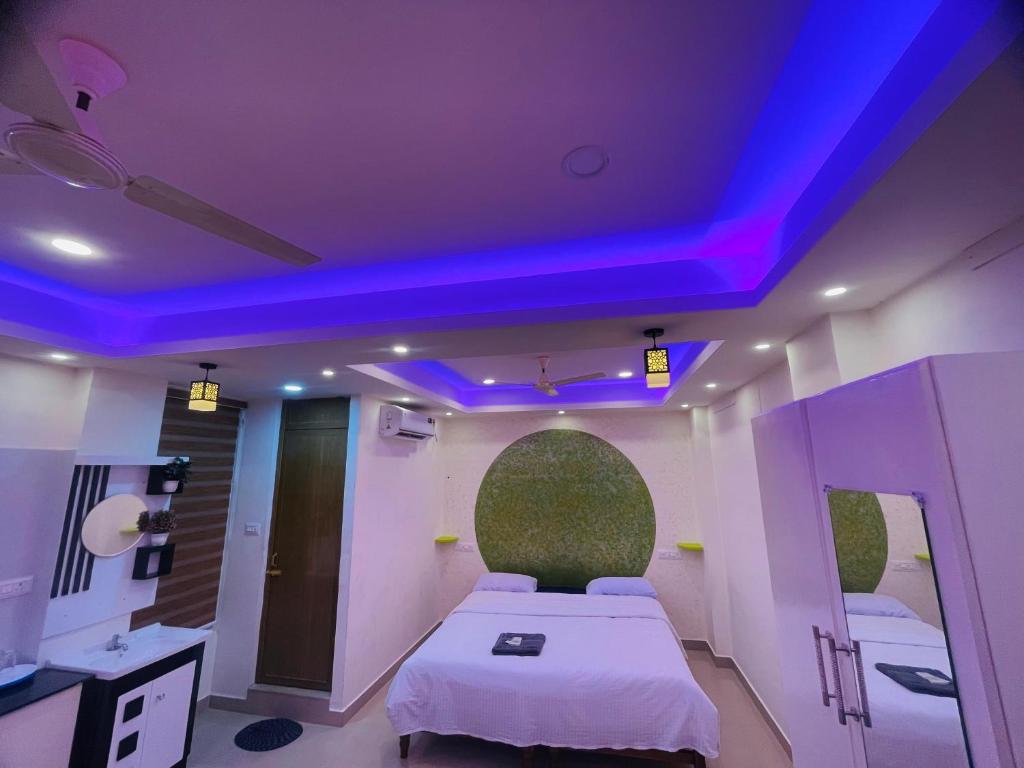a room with a bed with a purple ceiling at Studio suites in Trivandrum