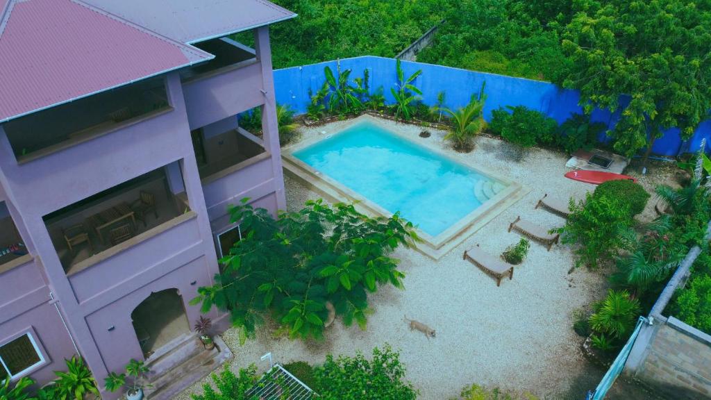 an overhead view of a swimming pool next to a building at Binta Boutique Hotel in Nungwi