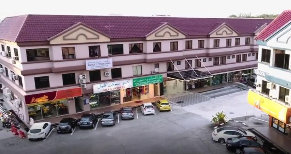 an overhead view of a building with cars parked in a parking lot at Al Afiah Hotel in Bandar Seri Begawan