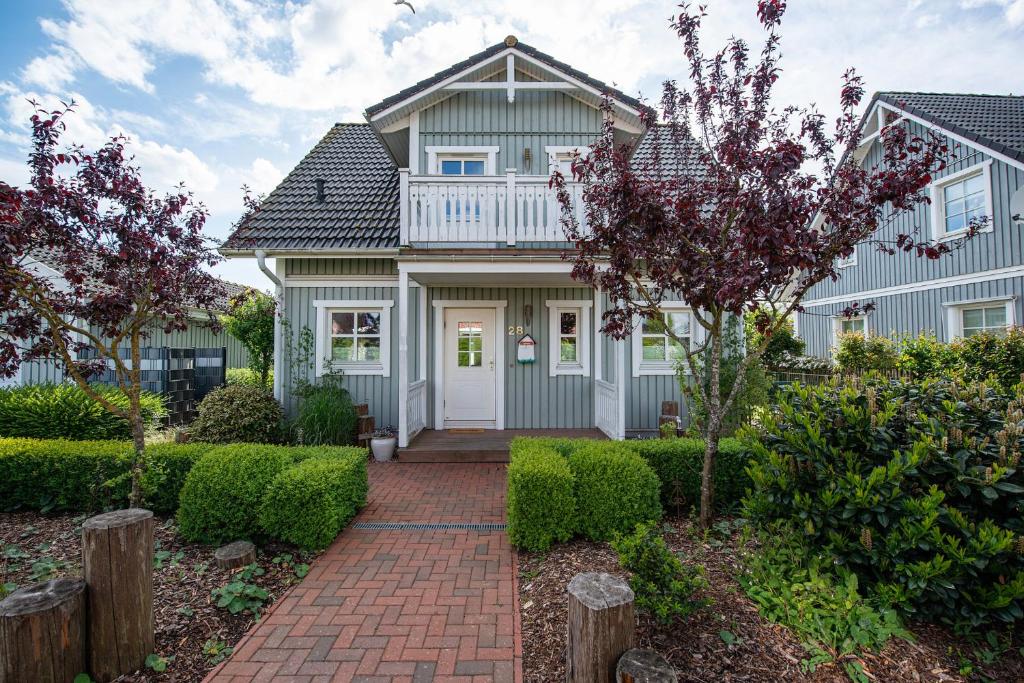 a house with a brick walkway in front of it at Ferienhaus Witt in Neue Tiefe Fehmarn