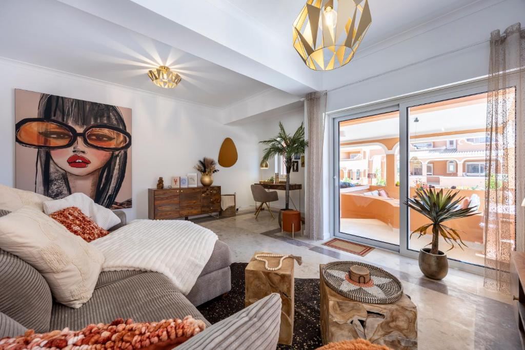 a bedroom with a large painting of a woman with glasses at DeCaNa Prestige Apartment - Gated Community Algarve in Porches