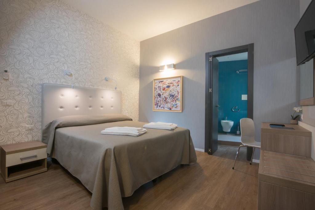 Łóżko lub łóżka w pokoju w obiekcie B&B Fantasie Romane