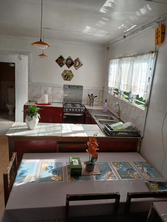 a kitchen with a sink and a counter top at Grace Homestay in Rewasau