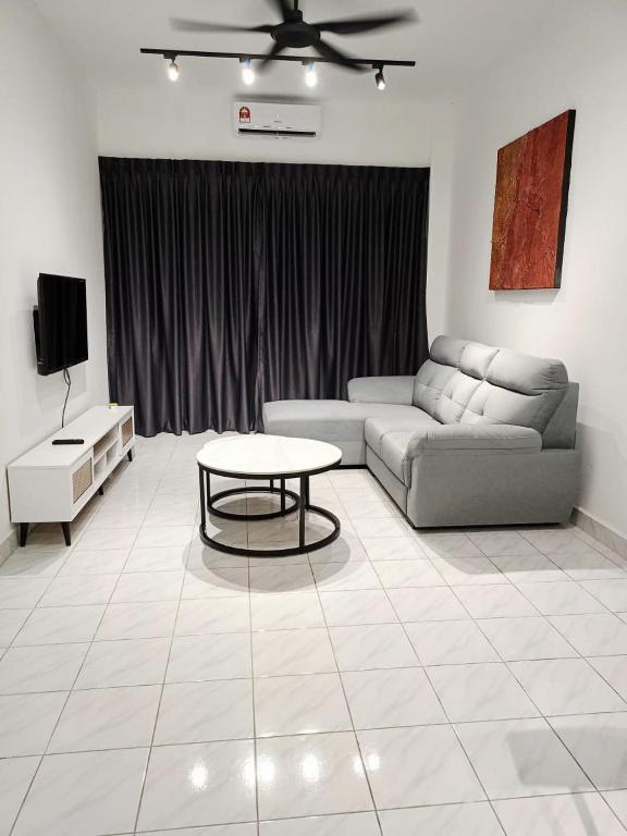 a living room with a couch and a table at Malacca 3 bedroom Seri Serindit G01 in Malacca