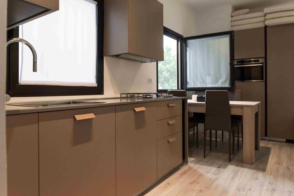 a kitchen with a sink and a table with chairs at rapisardi 8 in Riccione