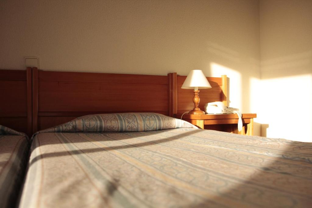 Postel nebo postele na pokoji v ubytování Residencial Dom Manuel