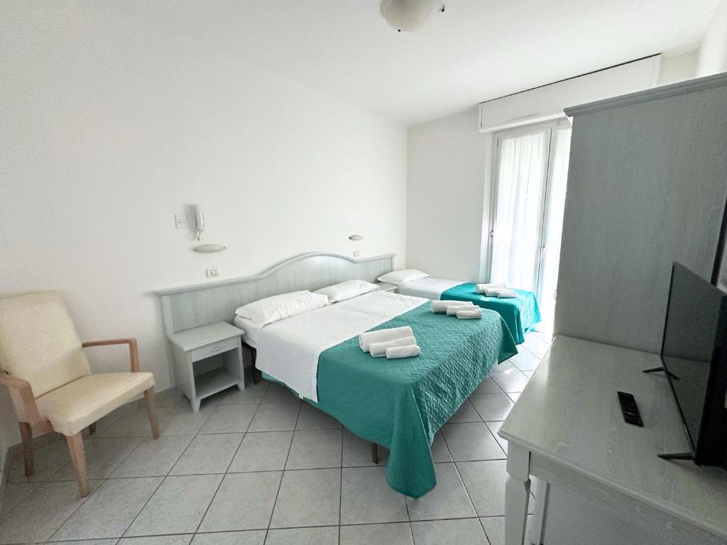 Postel nebo postele na pokoji v ubytování Hotel Ginevra e Residence