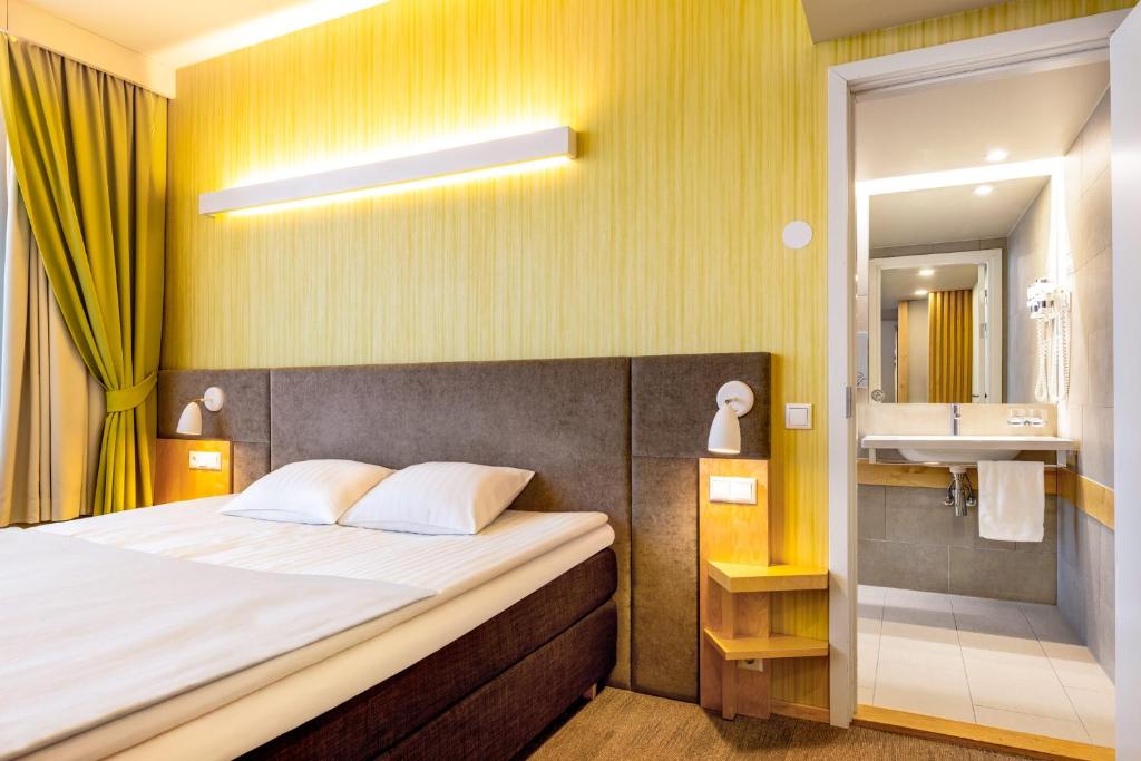 Postel nebo postele na pokoji v ubytování Hotel Tartu