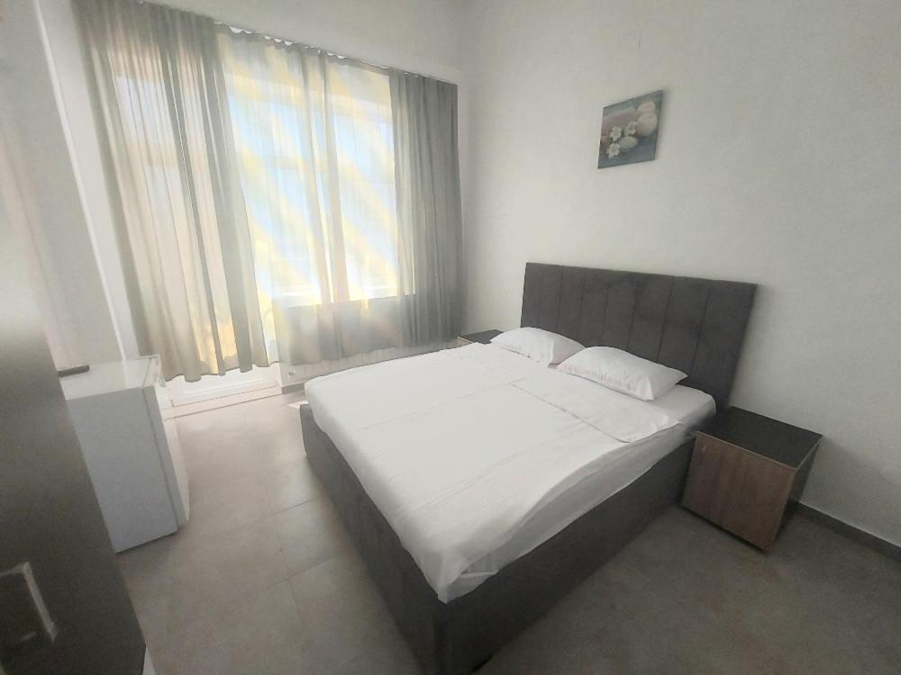 Postel nebo postele na pokoji v ubytování La Perla Bianca Residence