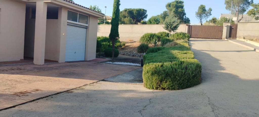 un vialetto con un garage e alcuni cespugli di Apartamentos Salma 20 a Toledo