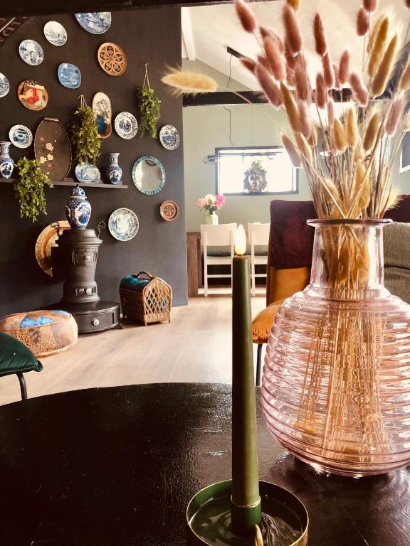 a vase with flowers in it sitting on a table at Retraitre bij de brug in Zuidveld