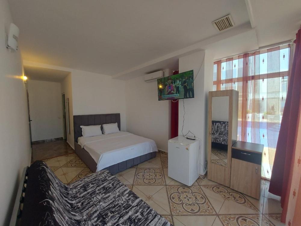Postel nebo postele na pokoji v ubytování La Perla Bianca Residence