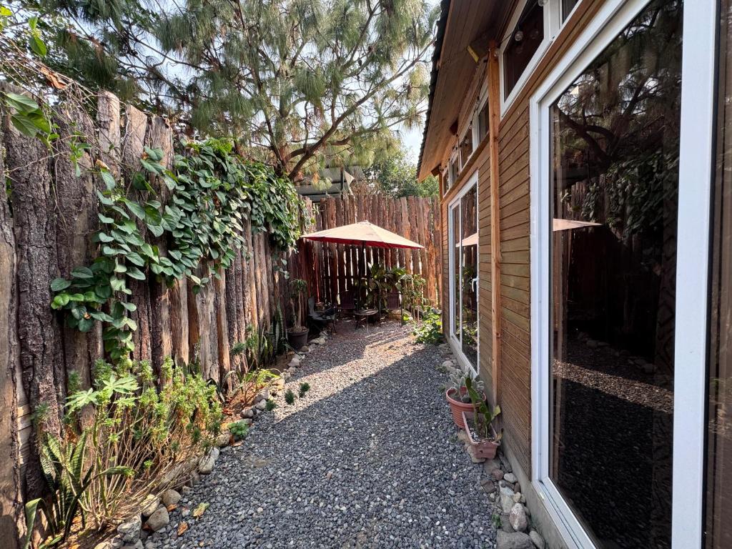 a walkway next to a fence next to a house at Cabaña Serenidad - Lago Atitlán in San Marcos La Laguna
