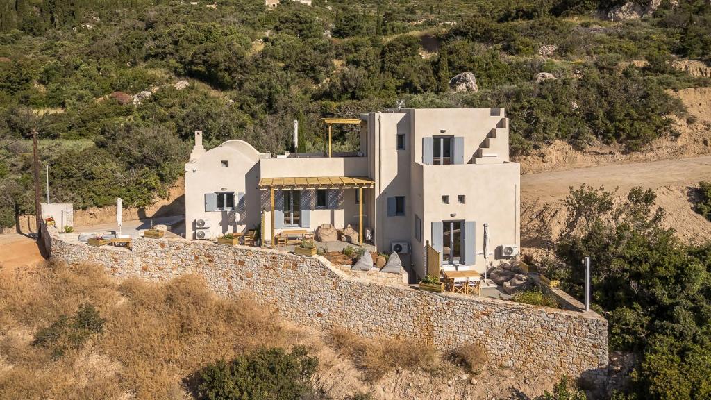 an aerial view of a house behind a wall at Comodo Studios in Kythira