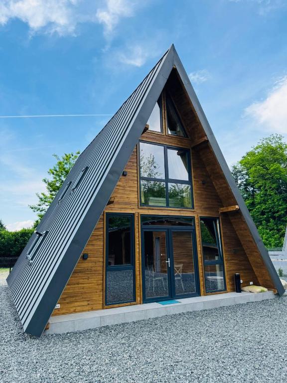 a frame house with a triangular roof at Cabana Twins A-Frame 1 in Sibiu