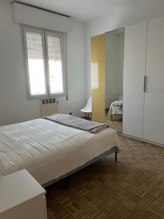 a bedroom with a large bed and a window at Via degli Dei house in Sasso Marconi