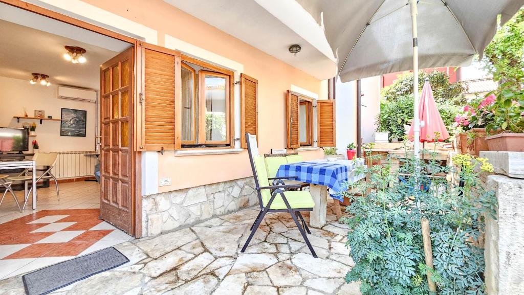 a patio with a table and an umbrella at Valentino in Novigrad Istria