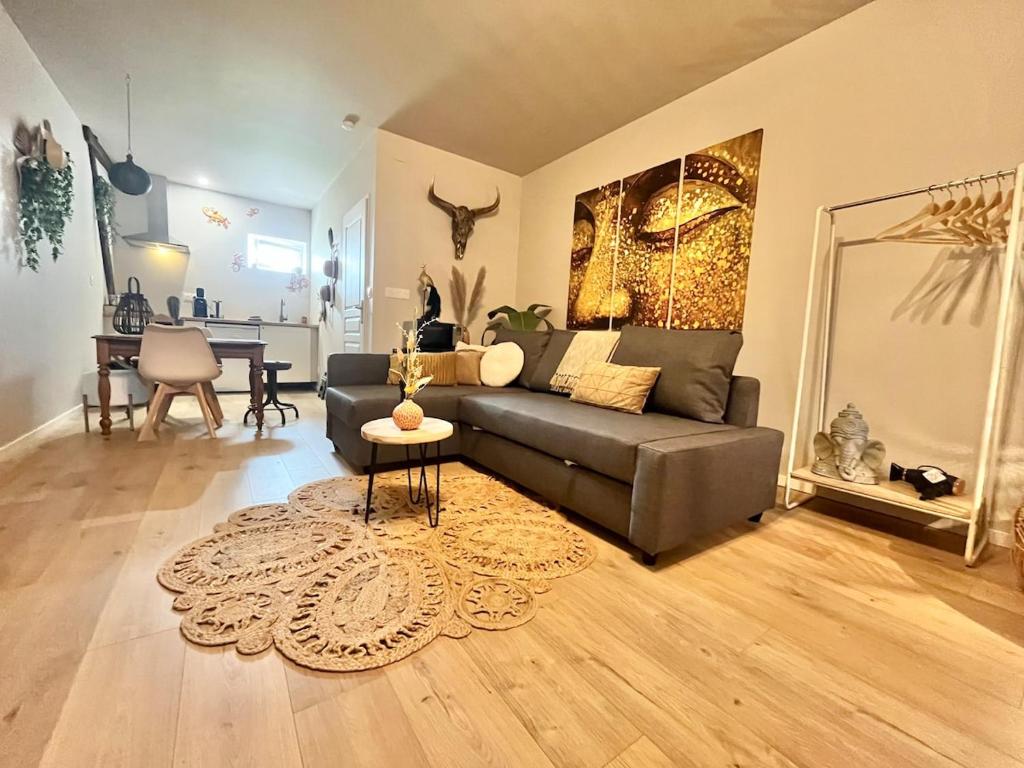 a living room with a couch and a table at "Gîte Ibiza" - AIRCO in Chamblet