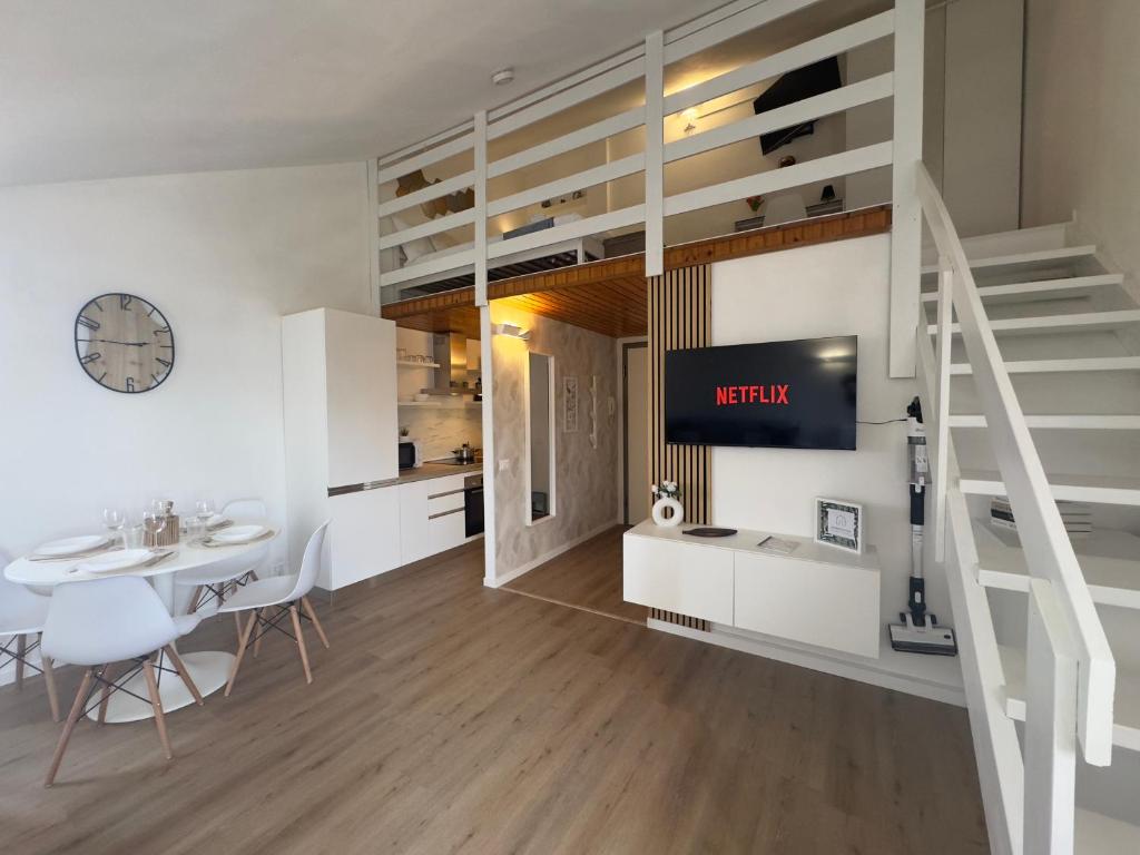 a living room with a loft bed and a dining room at La Mini Home - Dove sentirsi subito a casa in Monza