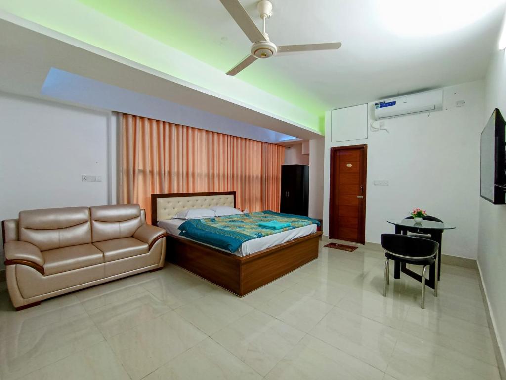 a bedroom with a bed and a couch and a table at Hotel ZN Palace 