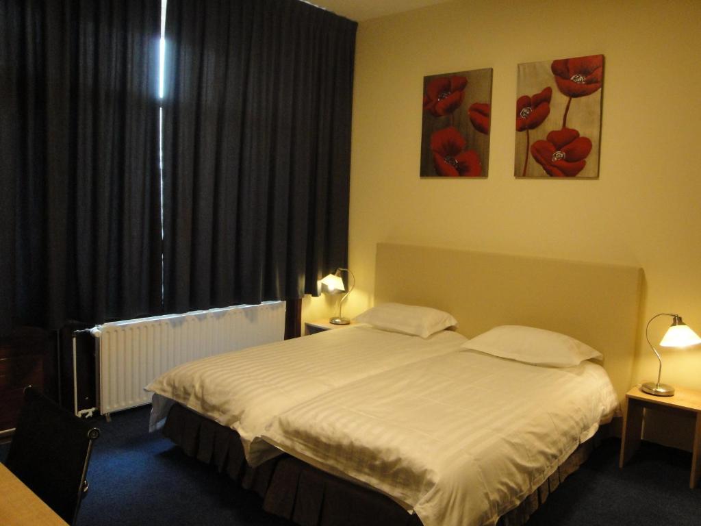 Postel nebo postele na pokoji v ubytování New City Hotel Scheveningen