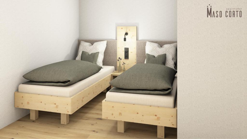 Postel nebo postele na pokoji v ubytování Aparthotel Maso Corto