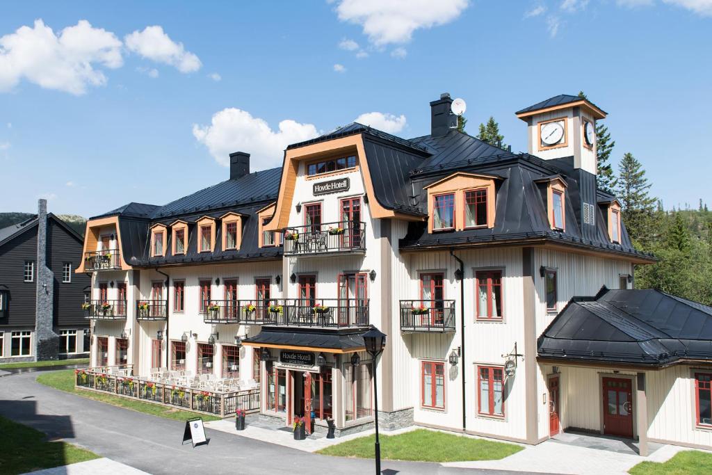 a large white building with a clock tower on it at Hovde Hotell in Vemdalsskalet