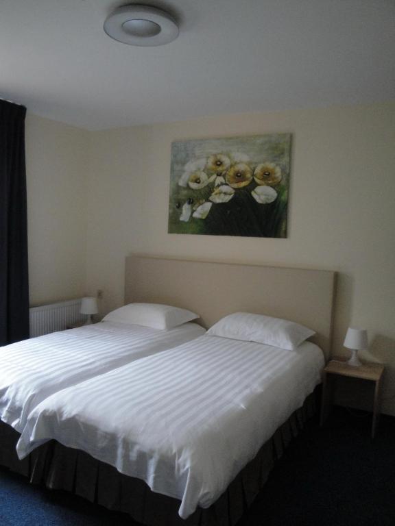 Postel nebo postele na pokoji v ubytování New City Hotel Scheveningen