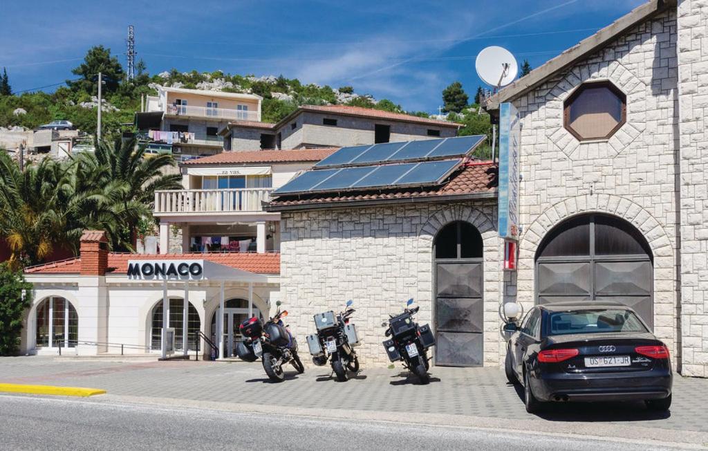 een groep motorfietsen geparkeerd voor een gebouw bij Apartmani Monaco in Ploče