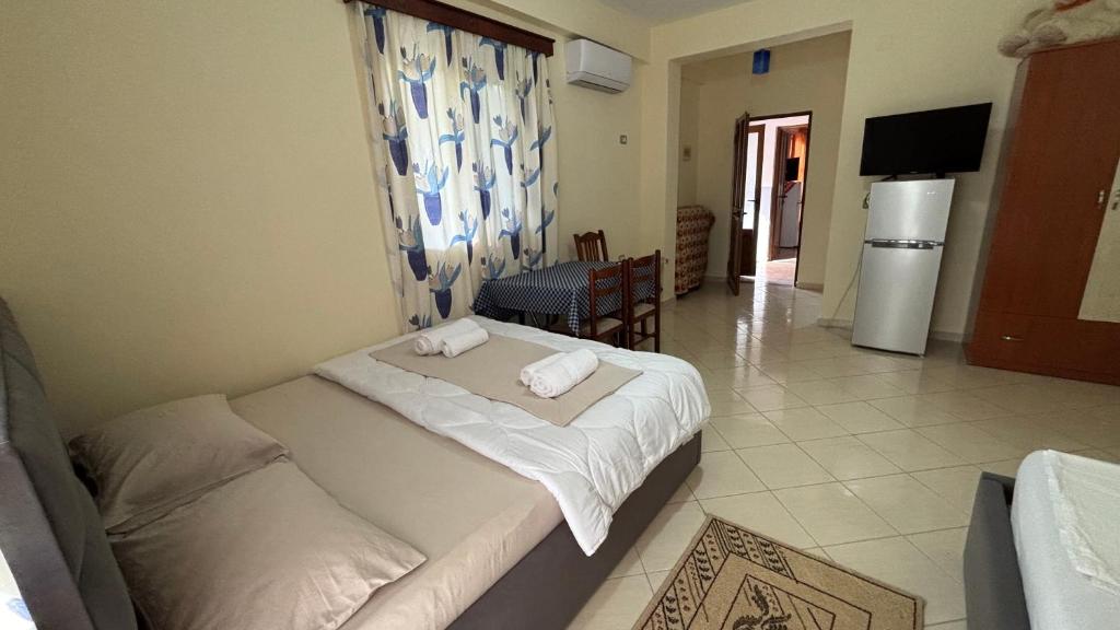 a hotel room with two beds and a television at Borsh Selavi Guest House in Borsh