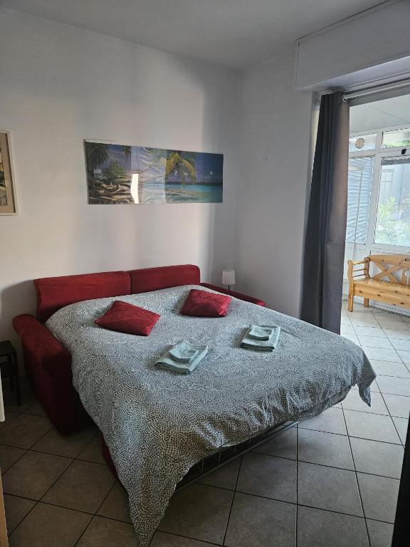 a bedroom with a bed with two pillows on it at Victoria's House in Rapallo