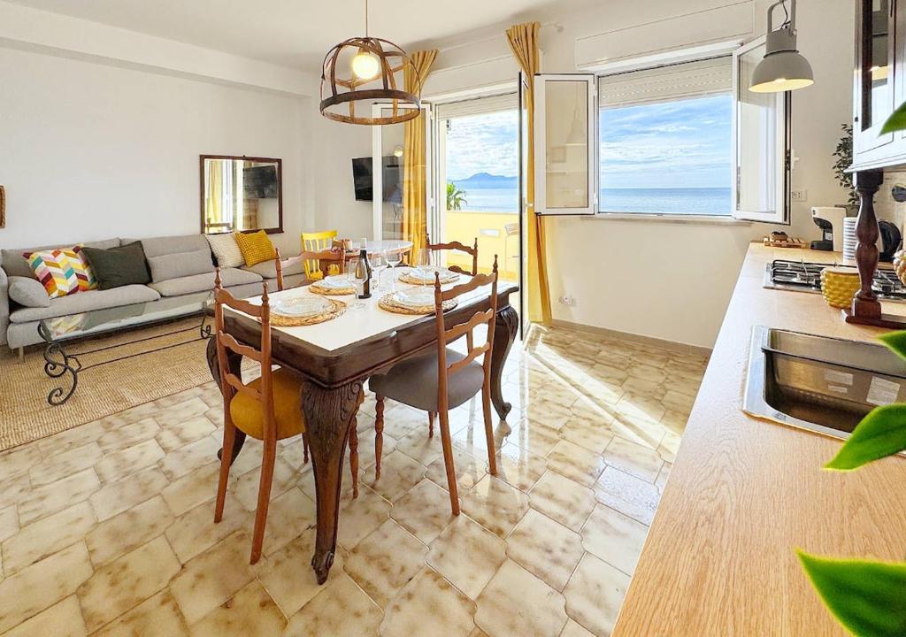 a living room with a table and chairs and a couch at Solemar Sicilia - Casa Dolce in Bagheria