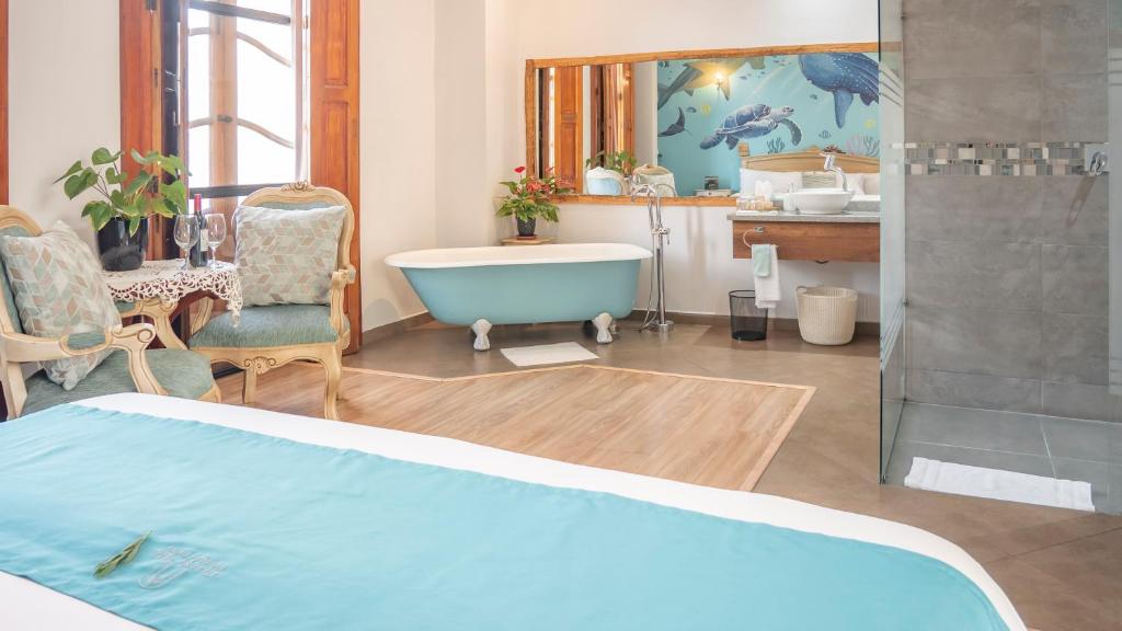 a bathroom with a bath tub and a sink at Boutique Hotel Casona 1914 Old Town Quito in Quito