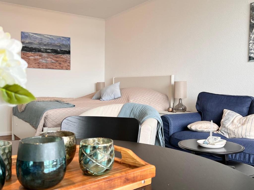 a room with a bed and a table and a couch at Baltic Sea View in Fehmarn