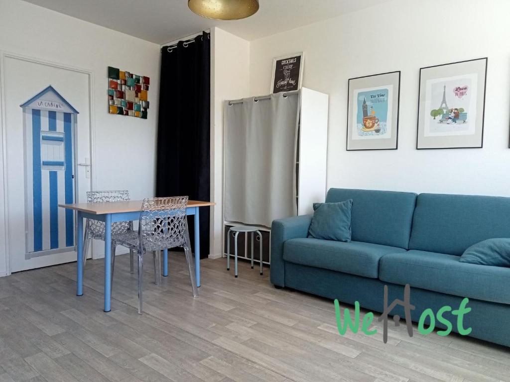 un salon avec un canapé et une table dans l'établissement Alfred - Studio - Seafront - Parking, à La Rochelle